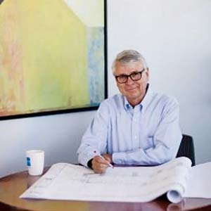 Gene Myers - at his desk with plans