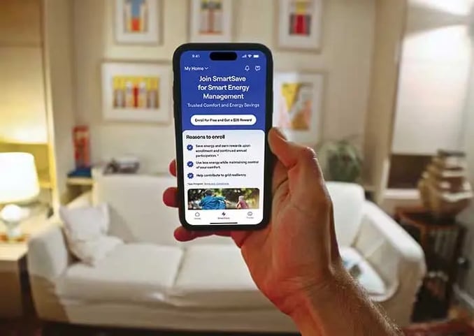 person-holding-a-phone-showing-the-carrier-smartsave-app