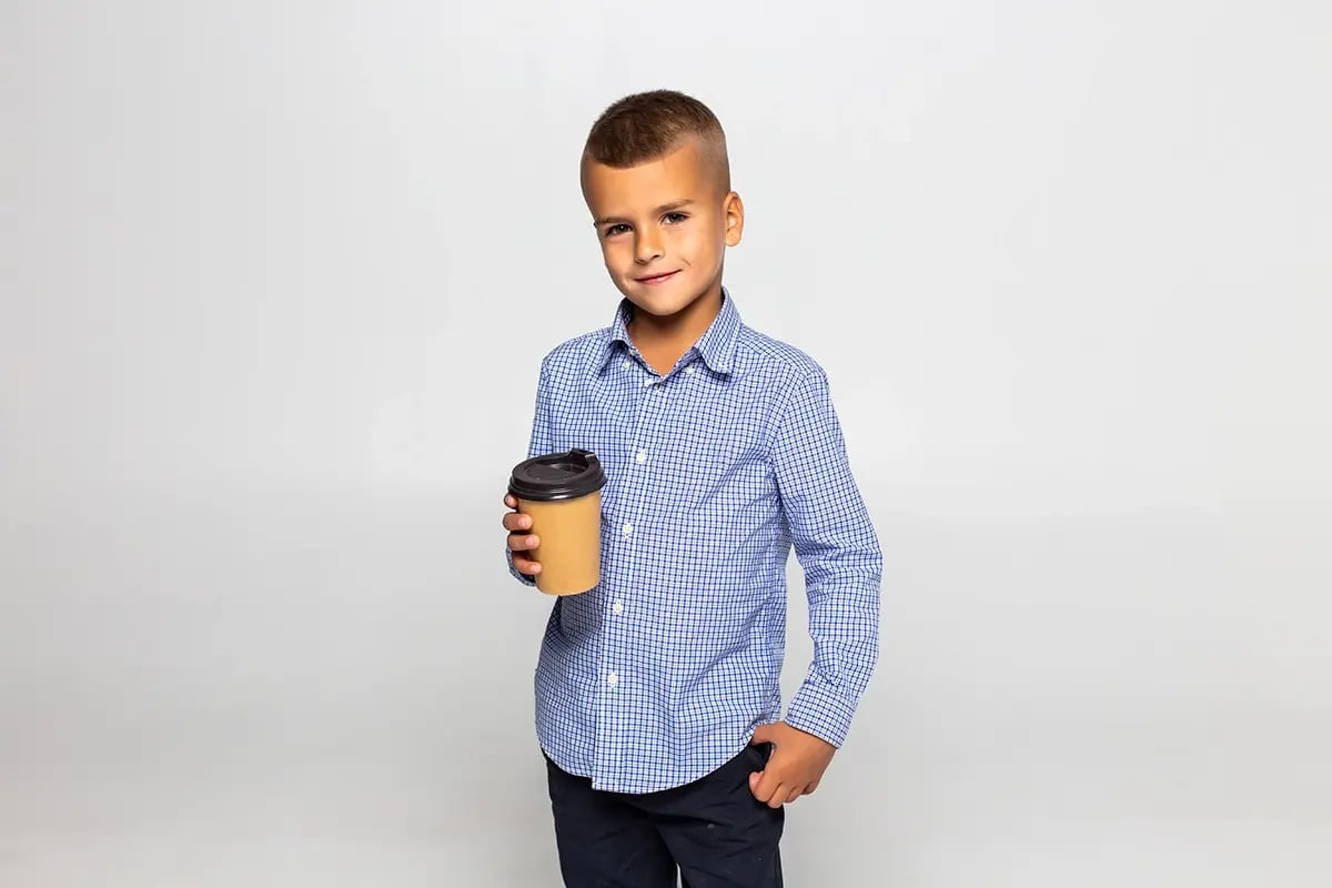 small-boy-coffee-cup-standing-isolated-white-wall