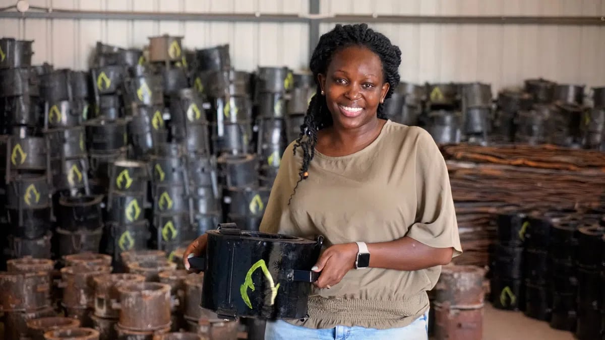 Charlot-Magayi-holds-a-Mukuru-Clean-Stove